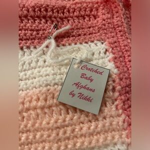 New, Hand Crafted Baby amAfghan with extra piece.